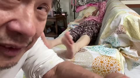 Luodong Massages His Wife's Feet On The Couch
