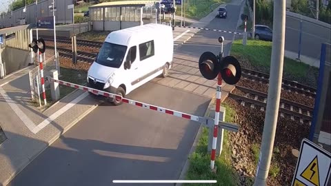 Van driver runs the red light and gets hit by a train