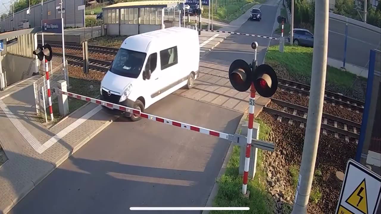 Van driver runs the red light and gets hit by a train