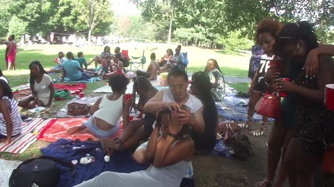 Luodong Briefly Massages Hand Of Attractive Black Woman At The Picnic