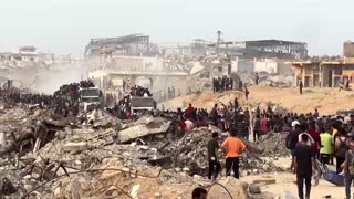 Palestinians receive aid supplies in Gaza's Beit Lahiya