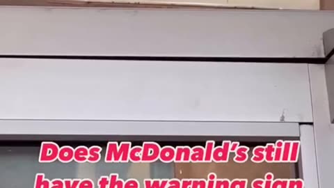 Why are McDonald's restaurants putting up signs warning customers?