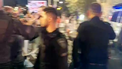 Israeli police violently take away 'resist genocide' banner from woman