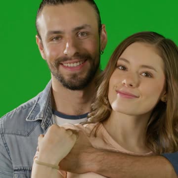 Happy couple posing with green background