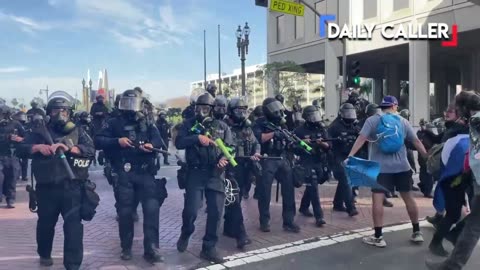 Protester in LA F's around with riot cops, immediately finds out when the projectiles start flying