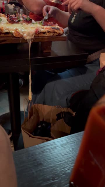 Pizza Cheese Stretches and Spills Into a Clothing Bag
