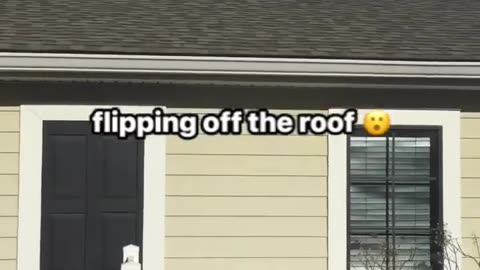 A gymnastics tumbling routine from a roof top to a yard