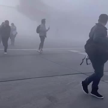 WATCH: Passengers evacuating after American Airlines plane catches fire at Denver airport