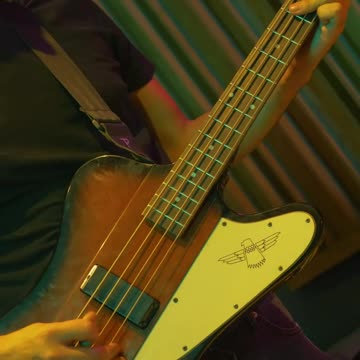 Bass player playing on top of a live stage