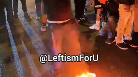Leftist rioter burns American flag in LA