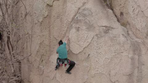 Male alpinist climbing a rocky mountain