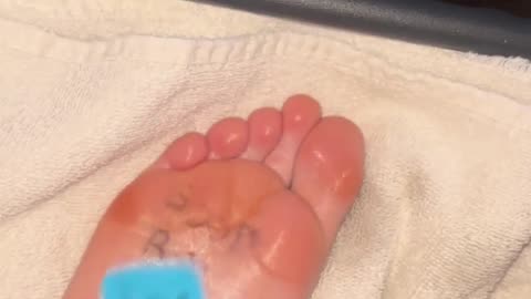 Feet tickled with blue brush oiled tooth brush