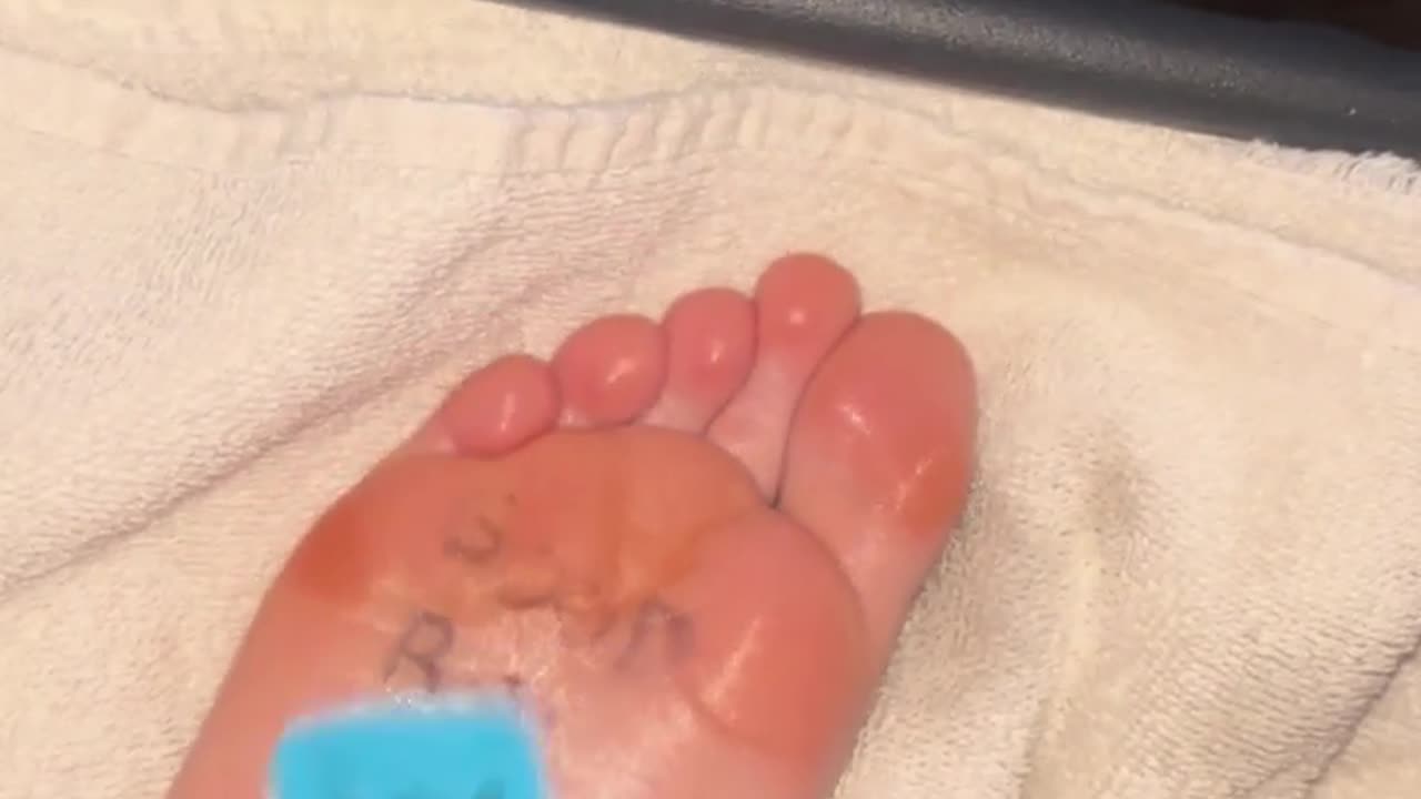 Feet tickled with blue brush oiled tooth brush