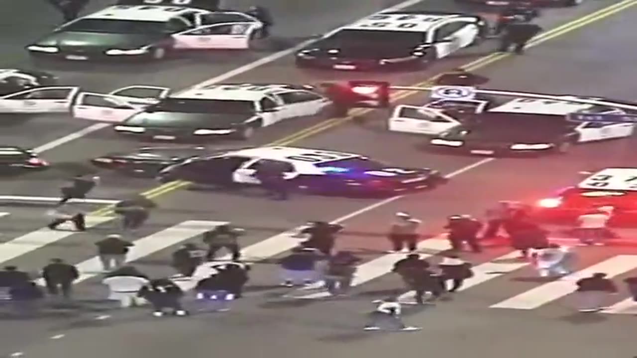 FAKE RIOT RENT A CROWD 33 ON TOP OF PATROL CAR.