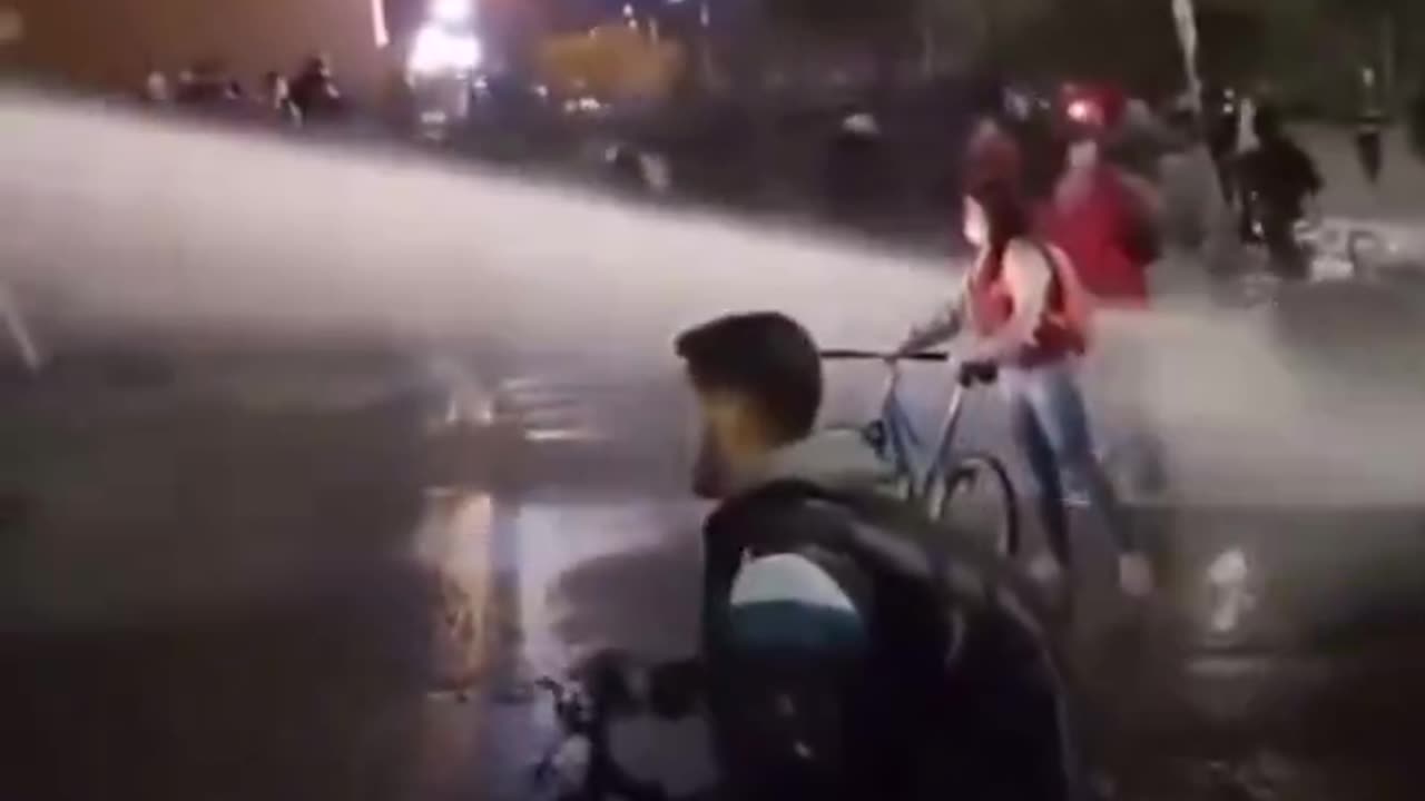 Will the mask protect this liberal protestor from the water cannon?