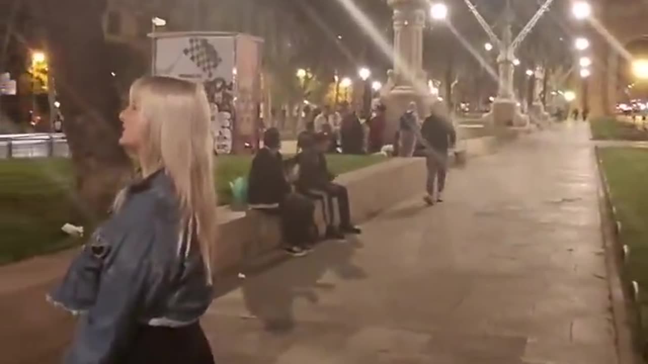 Spanish girl shows us Barcelona at night. There are no spanish men in video.