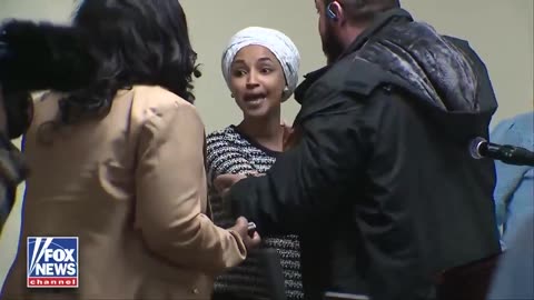 Some dude charges Ilhan Omar and sprays her with something at town hall