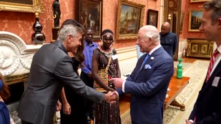 King Charles greets the Clooneys at palace reception