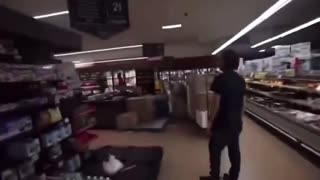 Two blacks harass a grocery store worker.