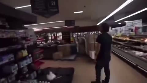 Two blacks harass a grocery store worker.