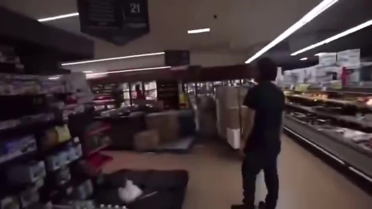 Two blacks harass a grocery store worker.