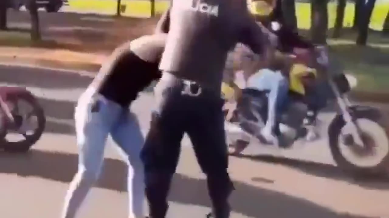 Woman slaps cop..