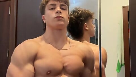 17 years old teen boy flexing muscles