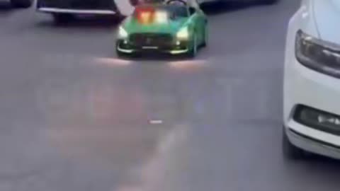 Adults responsible for this little kid let her drive a mini car in the middle of the street