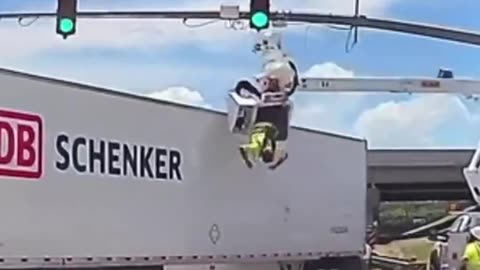 18-wheeler struck a utility worker from above leaving him dangling in midair.