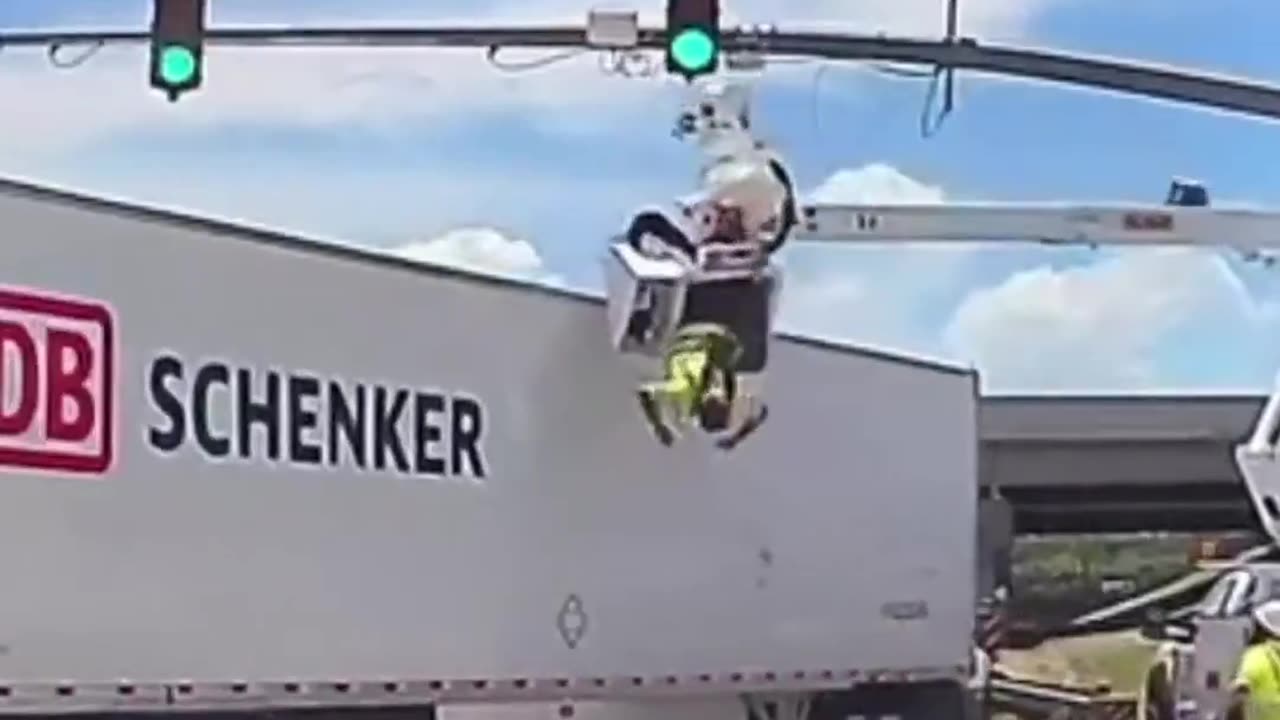 18-wheeler struck a utility worker from above leaving him dangling in midair.