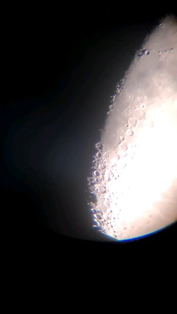 looking at the moon using phone through a telescope