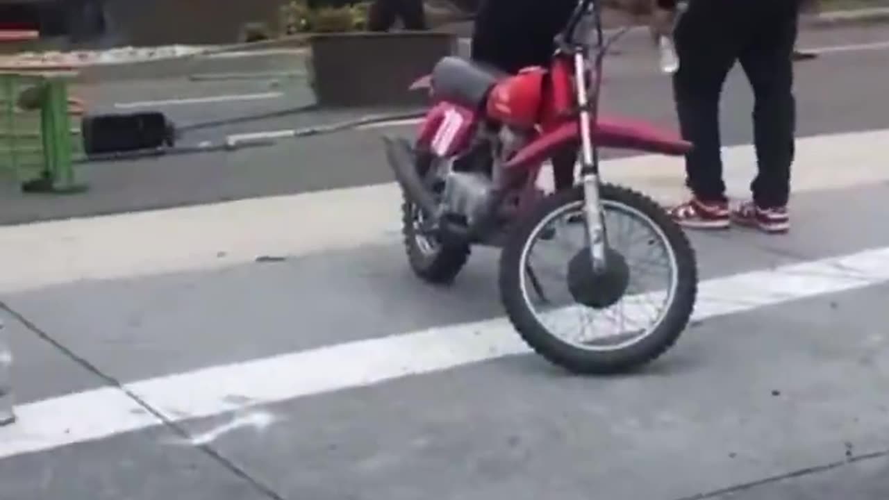 LA protests. Rock thrower was riding a red dirt bike.