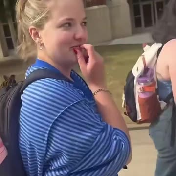 Student at University of Oklahoma tramples on TPUSA signs.