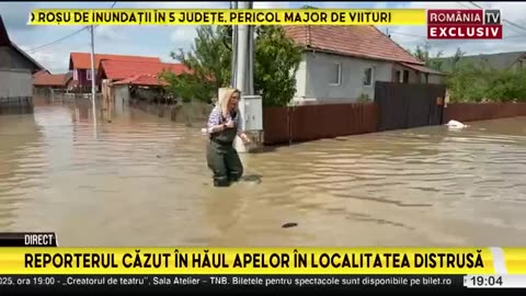 Romanian journalist falls into hole while filming report on flood-stricken region