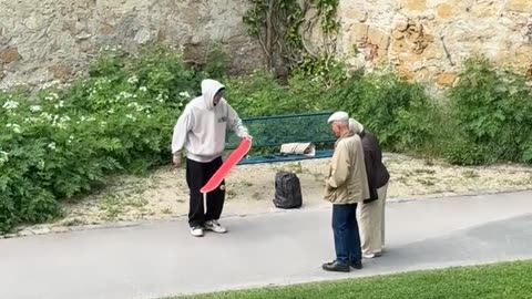 Skateboarder Explains Trick To Elderly Couple