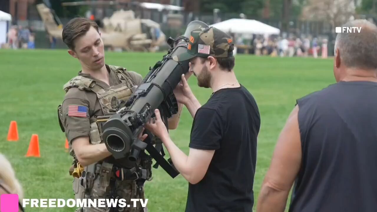 Military Parade attendees pose with weapons and tanks in Washington DC