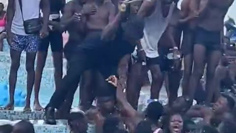 The crowd tries to abuse a woman.