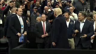 President Trump enters the Wells Fargo Center arena for the Division I NCAA wrestling championships