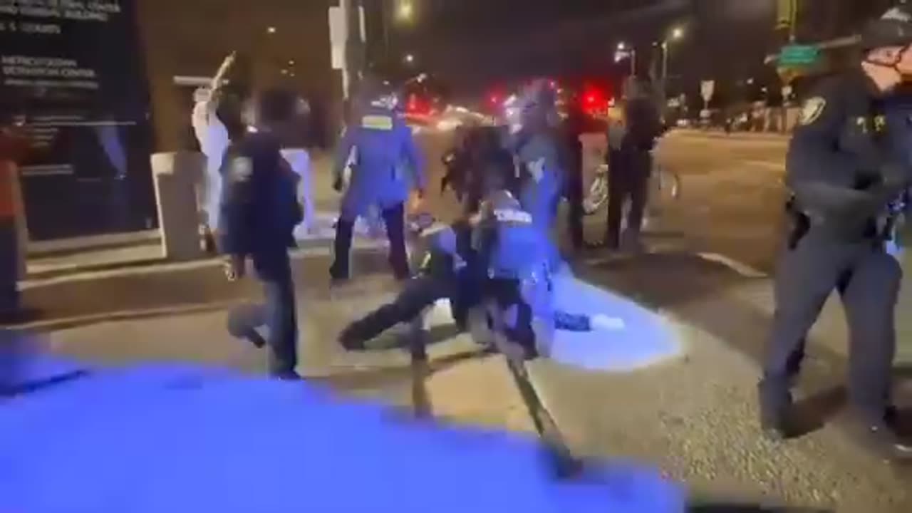 ICE sneak around to side and behind peaceful protester