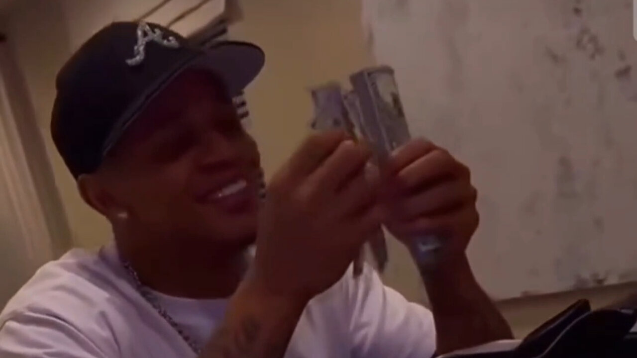 YK Osiris shows off the check he got for getting beat up