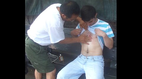 Luodong Massages White Man In Striped Shirt On The Bench