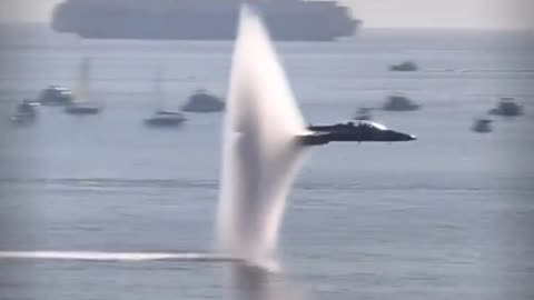 Amazing slo-mo tracking shot of a vapor cone forming around a transonic F-18.