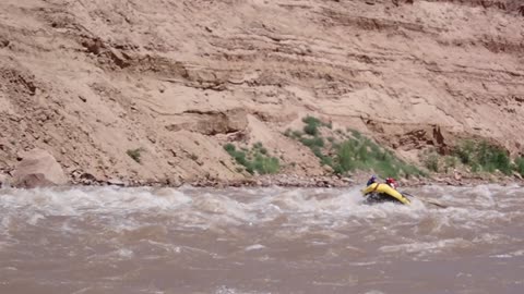 Watching a fellow raft descend the rapids in Cataract Canyon, Utah