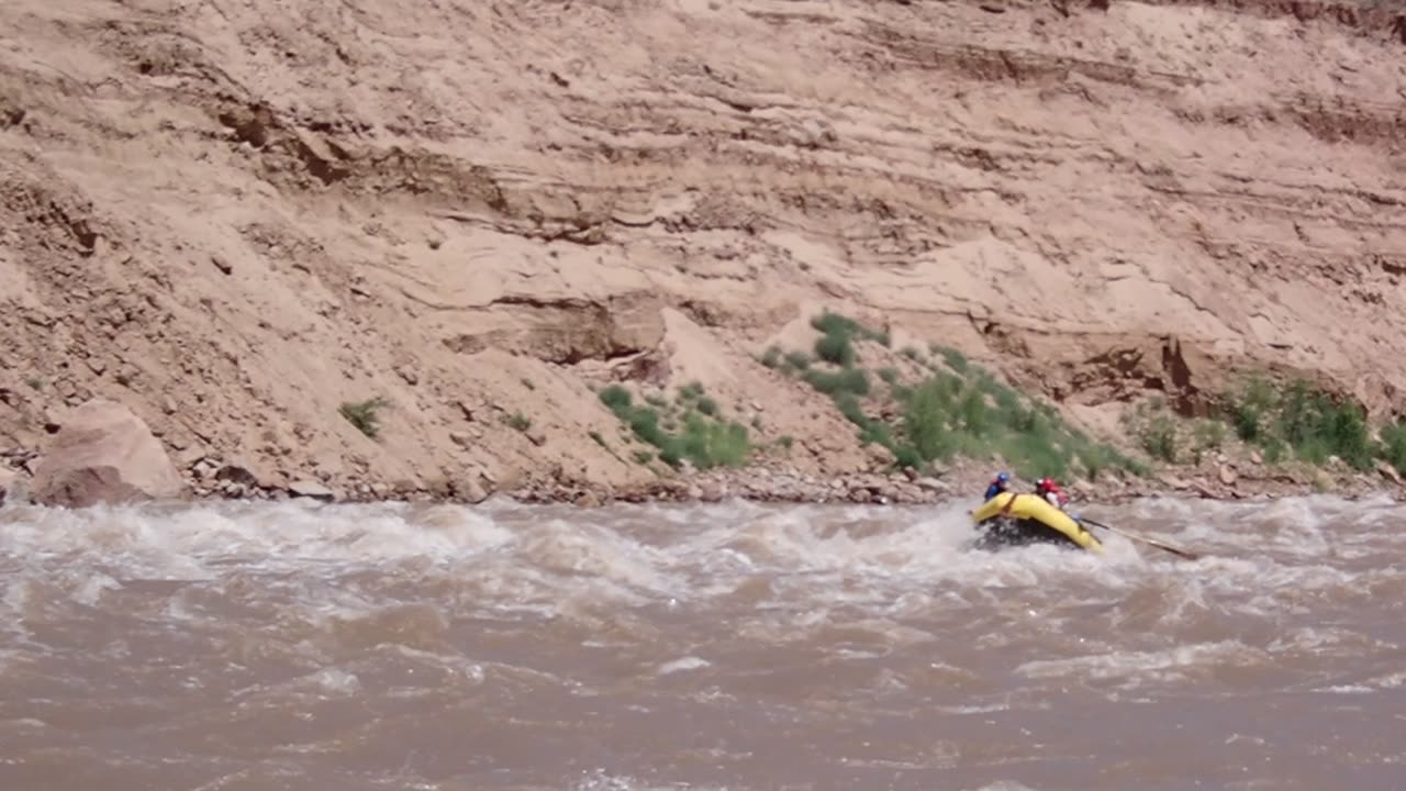 Watching a fellow raft descend the rapids in Cataract Canyon, Utah