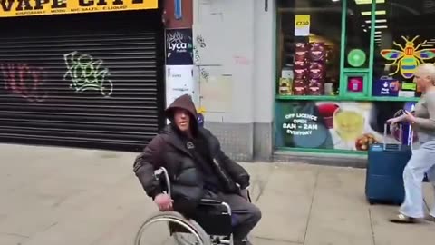 A man violently attacks a disabled man, knocking him out of his wheelchair.