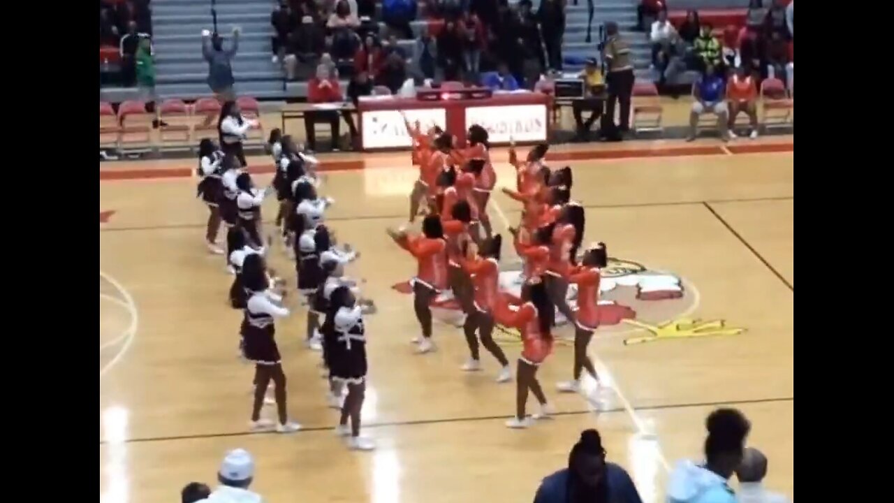 Group fight between 2 school's cheerleaders on basketball court