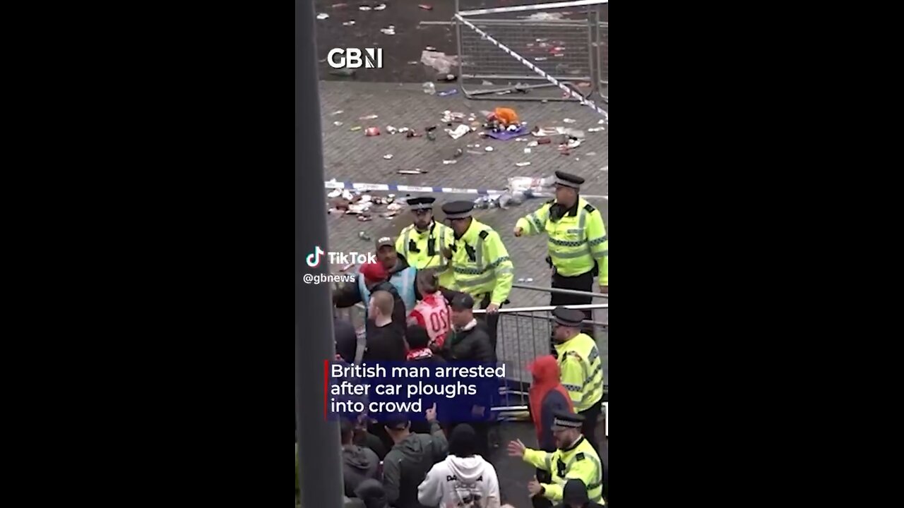 A third angle of the aftermath of a man driving through a crowd of Liverpool fans
