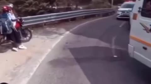 "Tourist on Bike Narrowly Escapes Getting Crushed by Car!"