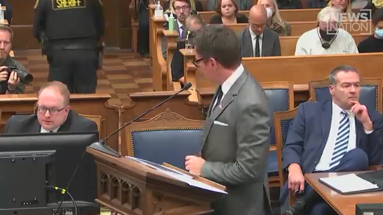 Prosecutor Binger points rifle at jury 2021 . Yikes! Does this idiot understand gun safety?