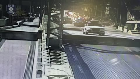 Stolen car crashing through a safety gate and jumping the partially open University Bridge